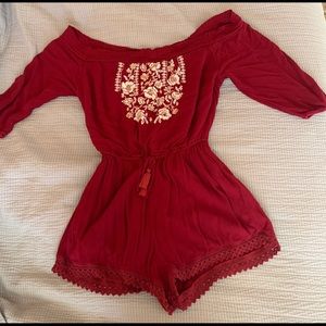 a red romper with white flowers